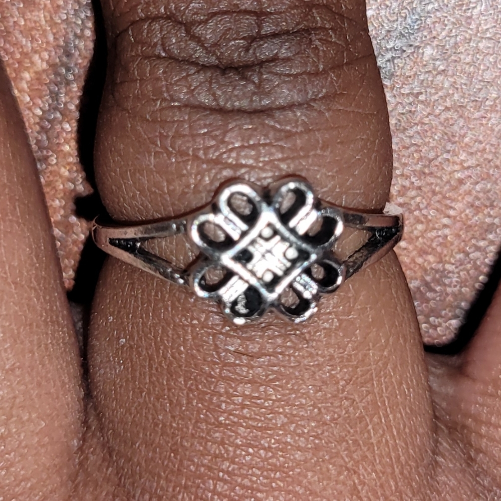 Silver ring with intricate flower design knuckle ring